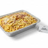 GRUB Singapore Bacon Carbonara Fusilli pasta tray for 8-12 people, topped with cheese and bacon bits.