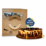 GRUB Singapore Signature Basque Burnt Cheesecake with a creamy centre and caramelized top, served with a birthday topper.