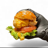 GRUB Singapore burger slider with sesame seed bun, lettuce, tomato, crispy chicken, and cheese sauce.