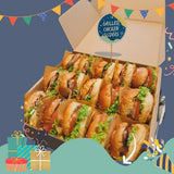 GRUB Singapore box of 15 mini grilled chicken sliders with lettuce and tomato on sesame seed buns, perfect for parties.