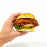 GRUB Singapore crispy chicken slider with lettuce and tomato on a sesame seed bun