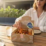 GRUB Singapore Crispy Fish Bites box with 50 pieces of breaded fish chunks and lemon wedges, served with a side of dip.