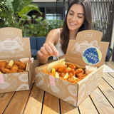 GRUB Singapore Crispy Fish Bites box with 50 pieces, breaded fish chunks served with lemon wedges and dipping sauce.