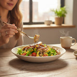 GRUB Singapore Grilled Chicken Salad with lettuce, corn, and honey mustard dressing, served in a white bowl.