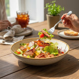GRUB Singapore Grilled Chicken Salad with cherry tomatoes, corn, lettuce, red onion, and pine nuts, served in a speckled bowl.