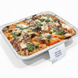 GRUB Singapore Grilled Chicken Tomato Fusilli pasta tray topped with grilled chicken, pesto, and parmesan cheese.