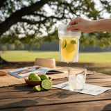 GRUB Singapore Honey Lime Drink in a pouch with lime slices, served outdoors at a picnic.