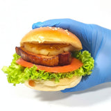 GRUB Singapore Maple Bacon Burger slider with lettuce, tomato, and pineapple on a sesame seed bun.