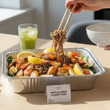 GRUB Singapore Miso Salmon Glazed Soba tray with soba noodles, salmon pieces, boiled eggs, lemon wedges, and cherry tomatoes.