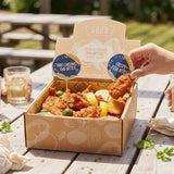 GRUB Singapore Mixed Bites Box with crispy fish and chicken bites, garnished with lime and lemon wedges.
