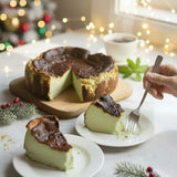 GRUB Singapore whole pandan burnt cheesecake with creamy centre and caramelised top, served on a wooden board with slices on plates.