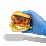 GRUB Singapore Crispy Portobello Mushroom Slider with lettuce, tomato, caramelized onions, and mayo on a brioche bun.