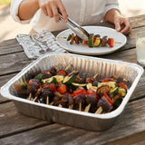 GRUB Singapore assorted vegetable yakitori skewers in foil tray, served outdoors on a wooden table.
