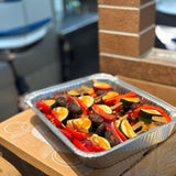GRUB Singapore assorted vegetable yakitori skewers in a foil tray with red bell peppers, zucchini, mushrooms, and red onion.